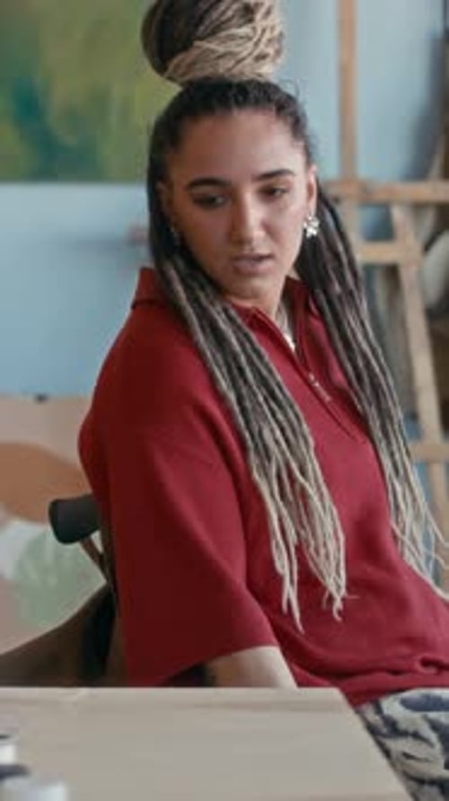 Vertical of Female Artist with Disability Entering Her Painting Studio