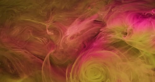 Abstract pink and yellow ink swirling beautifully underwater