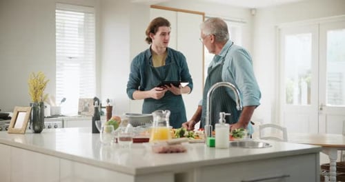 Men Cooking Together in Kitchen with Tablet