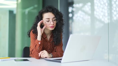 Woman Working at Computer Experiences Eye Strain