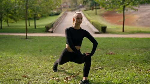Athletic Woman Stretching in Urban Park