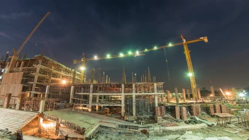 Night Shift Construction Building a High Rise Structure Under Site Lights
