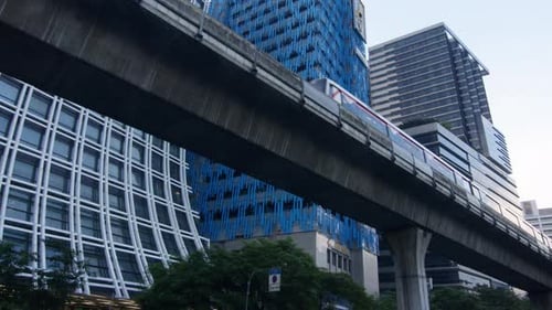 Elevated Train on a Track in Urban Bangkok with Modern Skyscrapers in the Background