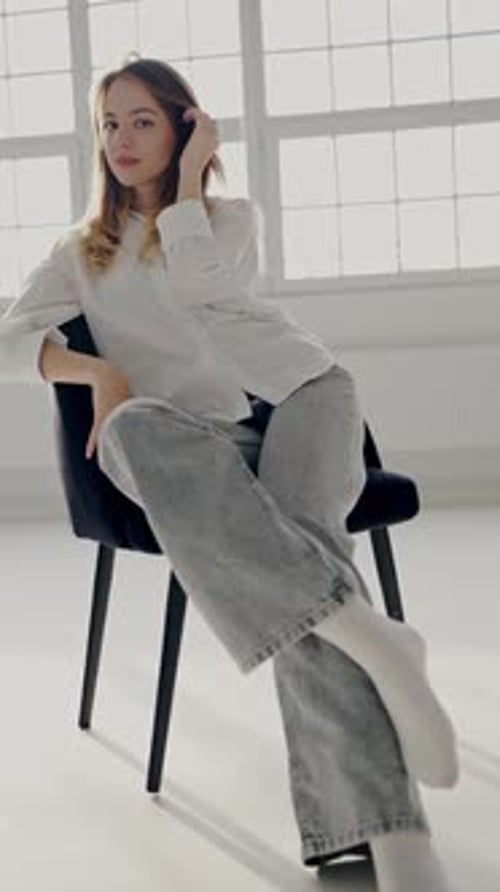Young Woman Sitting Casually in a Bright Sunlit Room