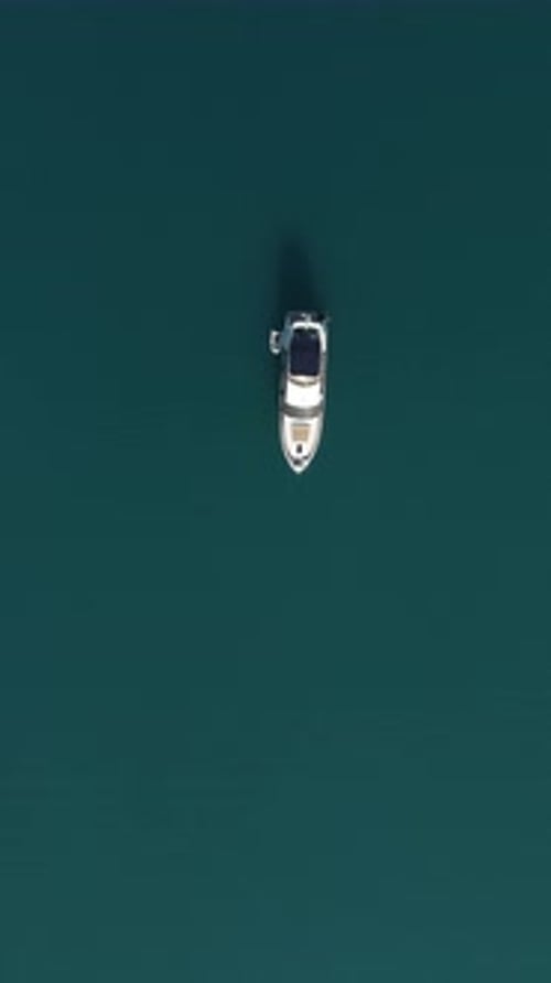 Aerial Yacht on Calm Sea Luxury Cruise Trip View From Above of White Boat on Deep Blue Water Aerial