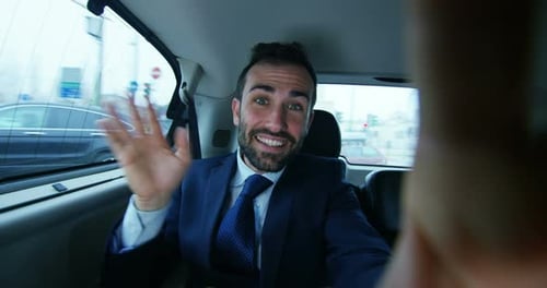 Man in Suit Riding in Car Waving