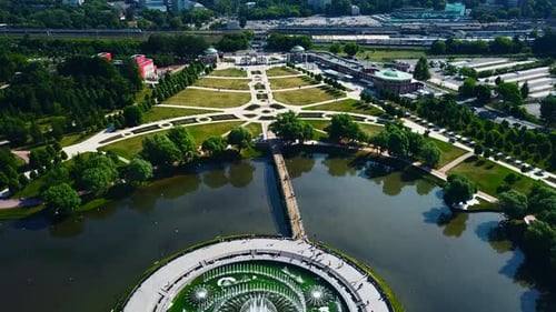 Historical park with fountain in pond and luxurious geometric alley.
