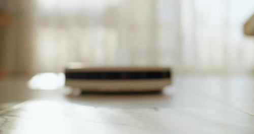 Robotic Vacuum Cleaner Moving Across Floor