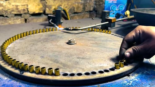 Ammunition Factory Worker Manually Producing Bullet Casings