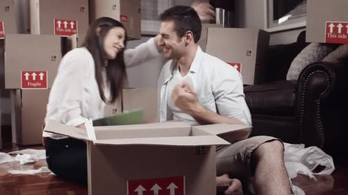 Young Couple Packing Belongings for Moving House