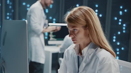 Scientists Working at Computers in Modern Lab