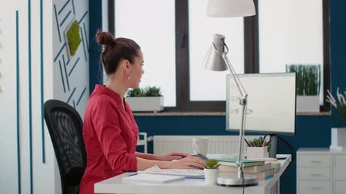 Focused Woman Works at Computer in Office