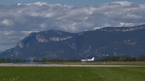 Small Propeller Plane Taxiing Before Mountains