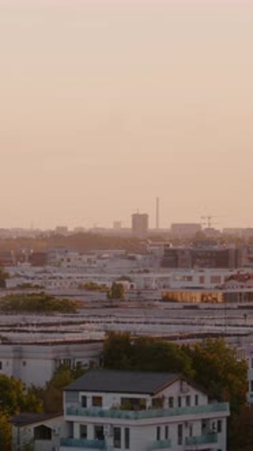 Vertical Screen Aerial view of downtown cityscape in distance at sunset.