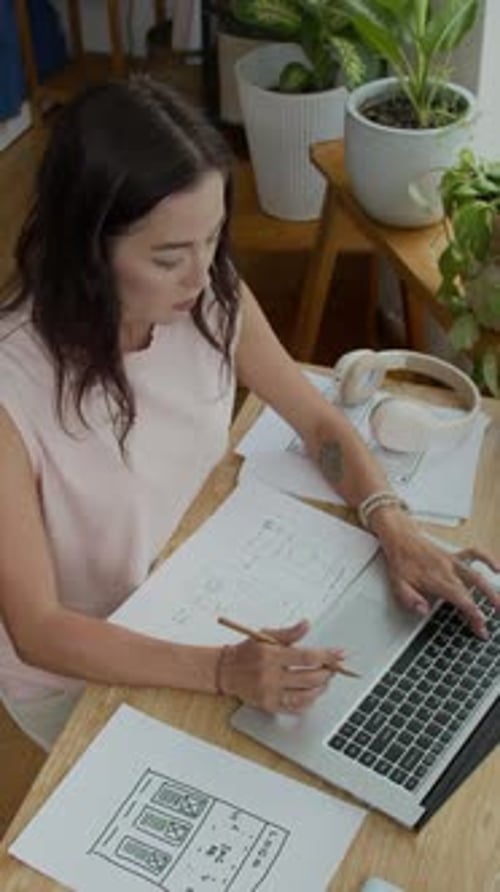 Businesswoman Using Laptop Drawing Sketch at Home Office