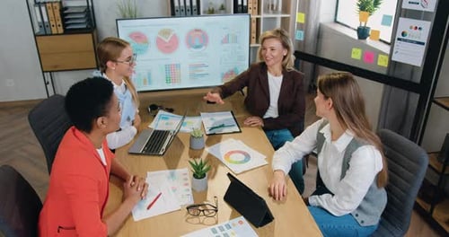 Business women celebration good teamwork result achieved stack hands on table together in office