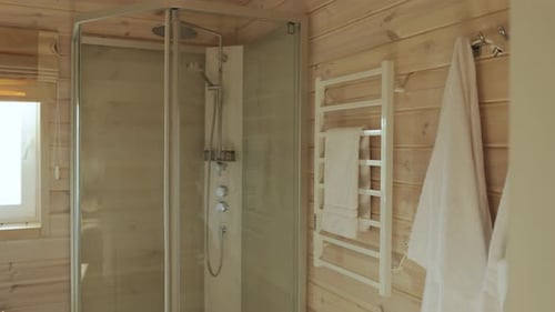 Stylish Bathroom with Modern Shower and Wood Paneling