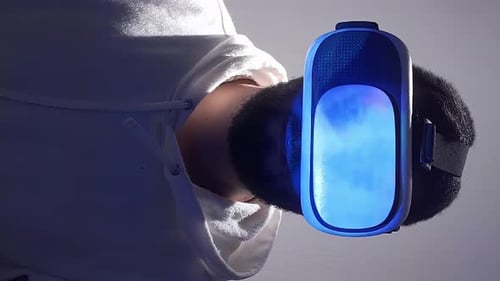 Person Wearing VR Headset with Blue Visuals