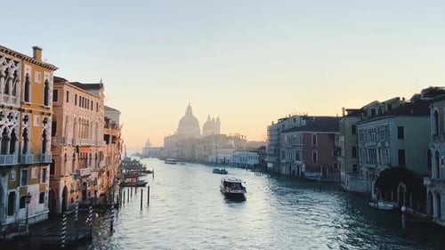 Early Morning View Of The Grand Canal From Accademia Bridge With Boats Cruising In Venice, Italy - t