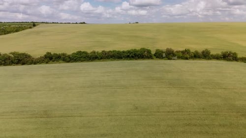 Tranquil Scenery with Rolling Hills Green Fields and Cloudy Sky Creating Serene Countryside View