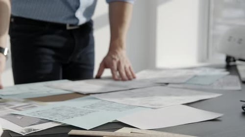 The Architect Works with Drawings on the Table Closeup Only Hands