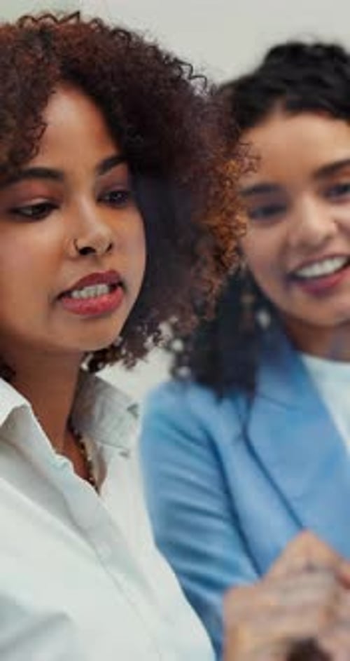 Women Collaborating at Whiteboard in Office Setting