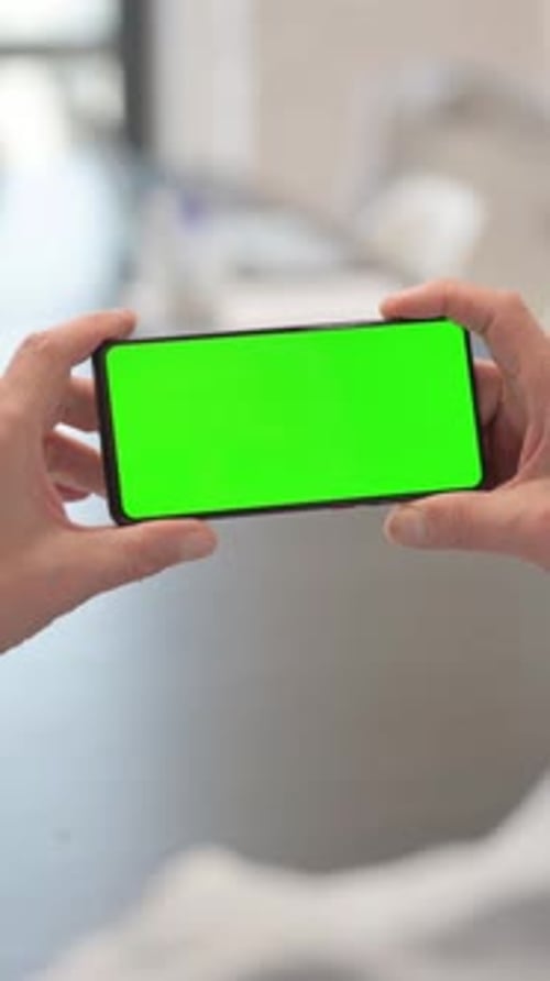 Holding Phone Horizontal with Green Screen