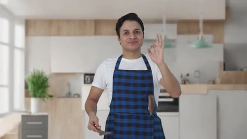 Happy Man Cooking in Modern Kitchen