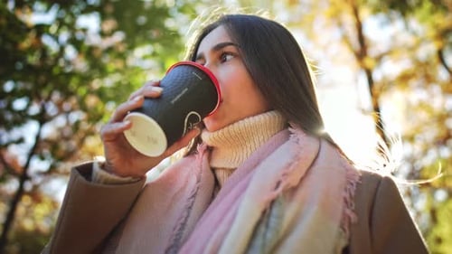 Portrait Caucasian Charming Lovely Dreamy Lady Hand Hold Glass Coffee and Enjoy Drink in Autumn Park