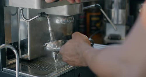 Closeup of Male Hands Barista Making Coffee with Modern Machine in Cafe
