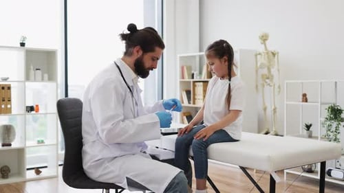 Doctor Carefully Administers Vaccine to Young Girl in Clinic