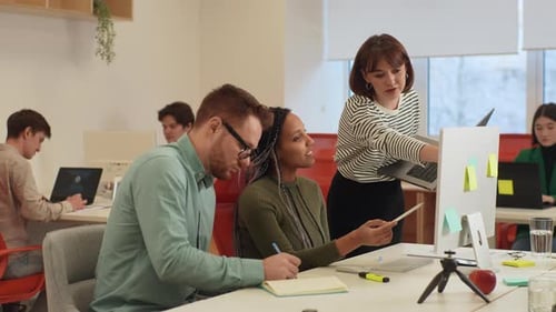 Colleagues Collaborate at Modern Office Workspace