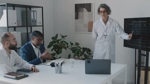 Medical Director Reporting at Clinic Meeting and Executive Asking Questions