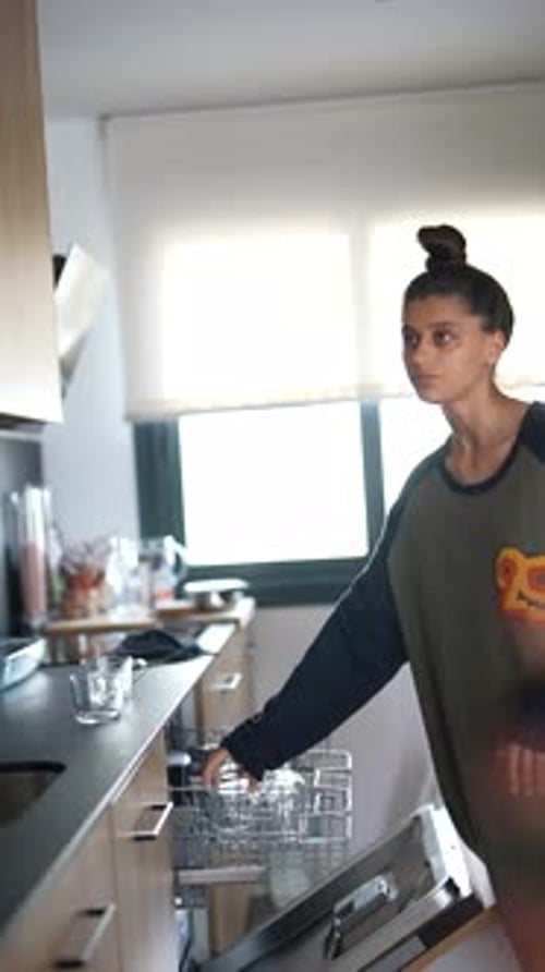 Woman Busy Organizing Appliances in the Kitchen a Typical Domestic Chore in a Modern Household