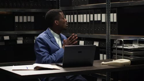 Man Working at Desk in Dark Office