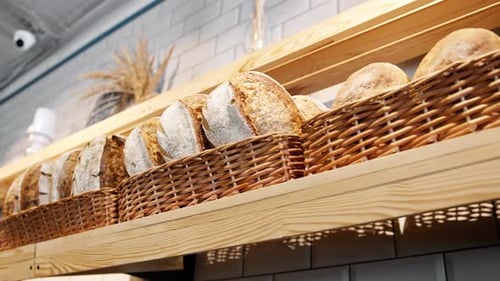 Freshly baked bread laid out in baskets on the bakery counter