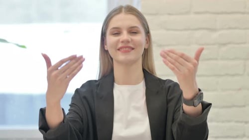 Inviting Businesswoman Pointing at the Camera