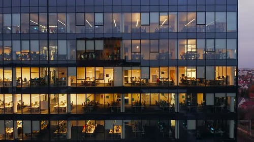 Cinematic Shot of Corporate Office Buildings Skyscrapers Illuminated at Night