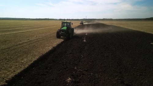 Tractors plowing the field in Ukraine