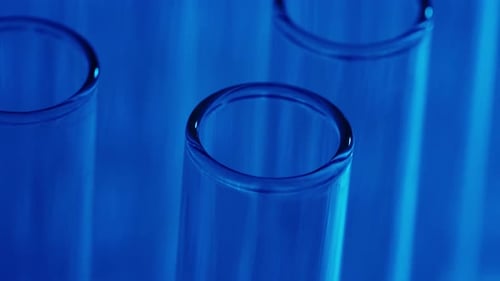Close Up Video Neon Blue Light Test Tubes in a Laboratory Scientific Experiment Research Study