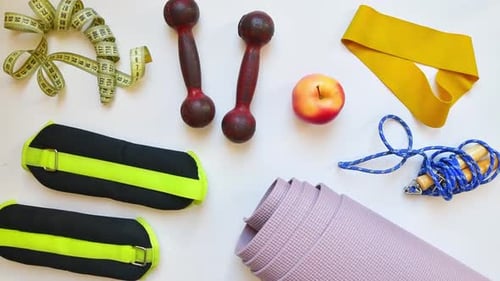 Fitness Still Life with Exercise Equipment and Apple