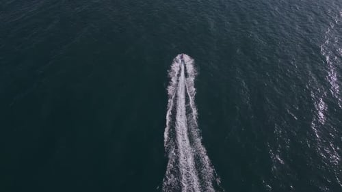 Aerial View of the Water Scooter or Personal Watercraft or Ski Jet Racing Through the Sea Waves