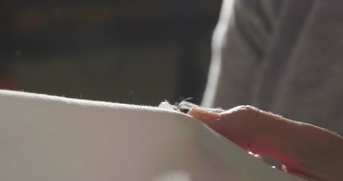 Close Up of Hands Sewing with Needle and Thread