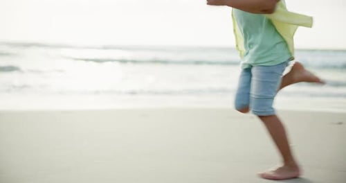 Happy, boy and run on beach for fun on summer vacation with freedom to explore in Thailand