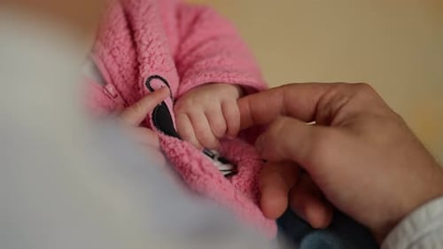 Loving Parent Holding Hand of Infant Child