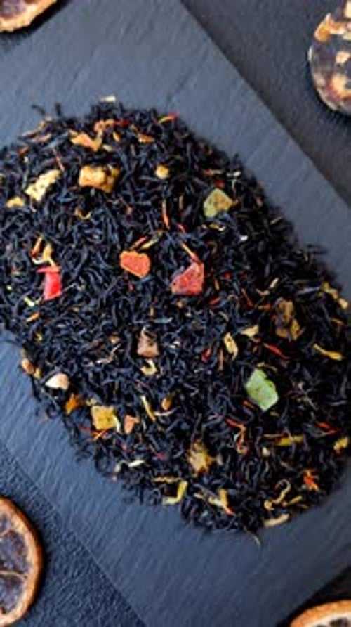 Dry black tea with herbal leaves and aromatic additives. Dry fruity black tea