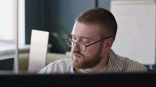 Man In Eyeglasses Working In Office