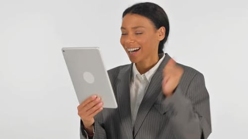 Portrait of African Businesswoman Celebrating Success on Tablet on White Background