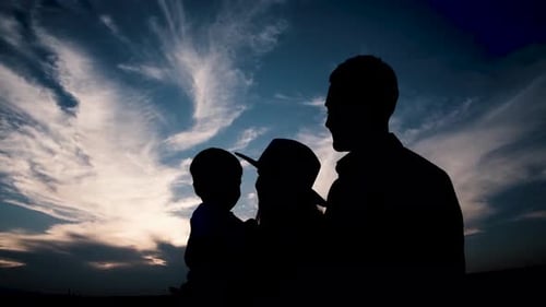 Silhouette Family Enjoying Sunset Together