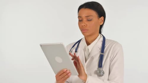 Female Doctor Using Tablet in Hospital Setting